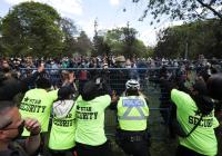Security and police try to prevent supporters from entering a homeless encampment as the camp's occupants await possible eviction by police after workers enclosed the area with a fence, at Trinity Bellwoods Park in Toronto, June 22, 2021.