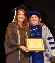 Brieana Smith receives the Howard B. Woolston Award from Professor Katherine Stovel, graduation 2024.