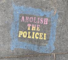Abolish the police written in chalk on the sidewalk