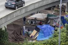 a homeless encampment under an off-ramp from Highway 90 near Dearborn Street South. (Steve Ringman / The Seattle Times)
