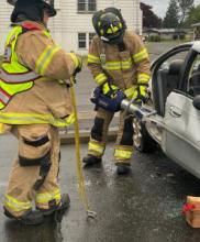 Firefighter using Jaws of Life tool
