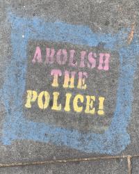 Abolish the police written in chalk on the sidewalk