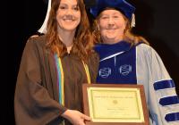 Brieana Smith receives the Howard B. Woolston Award from Professor Katherine Stovel, graduation 2024.