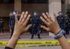 A demonstrator holds their hands up while they kneel in front of the police at the Anaheim City Hall on June 1, 2020 in Anaheim, California, during a peaceful protest over the death of George Floyd. (Apu Gomes/AFP/Getty Images)