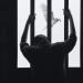 prisoner behind bars with free bird